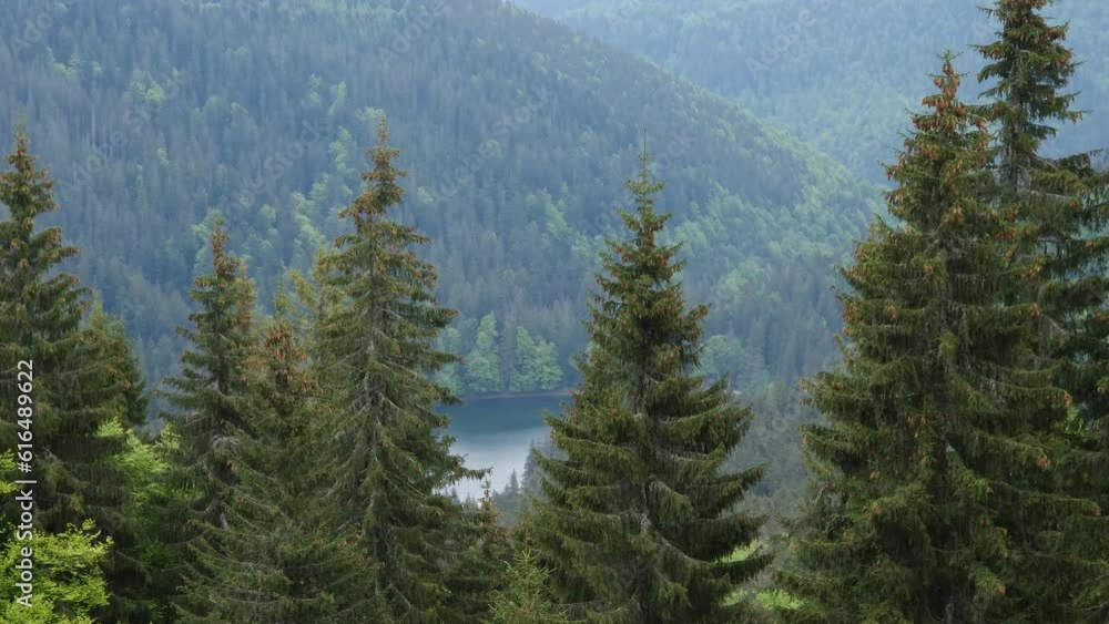 Lake among mountain ridges in spring day in Carpathian Mountains Lake among mountain ridges in spring day in Carpathian Mountains