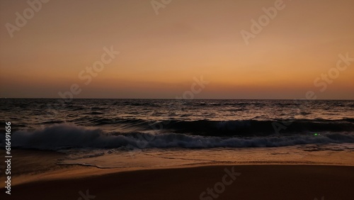 the evening sky at the beach with the waves of the sea 