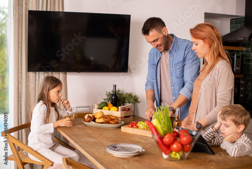 Young family preparing vege...