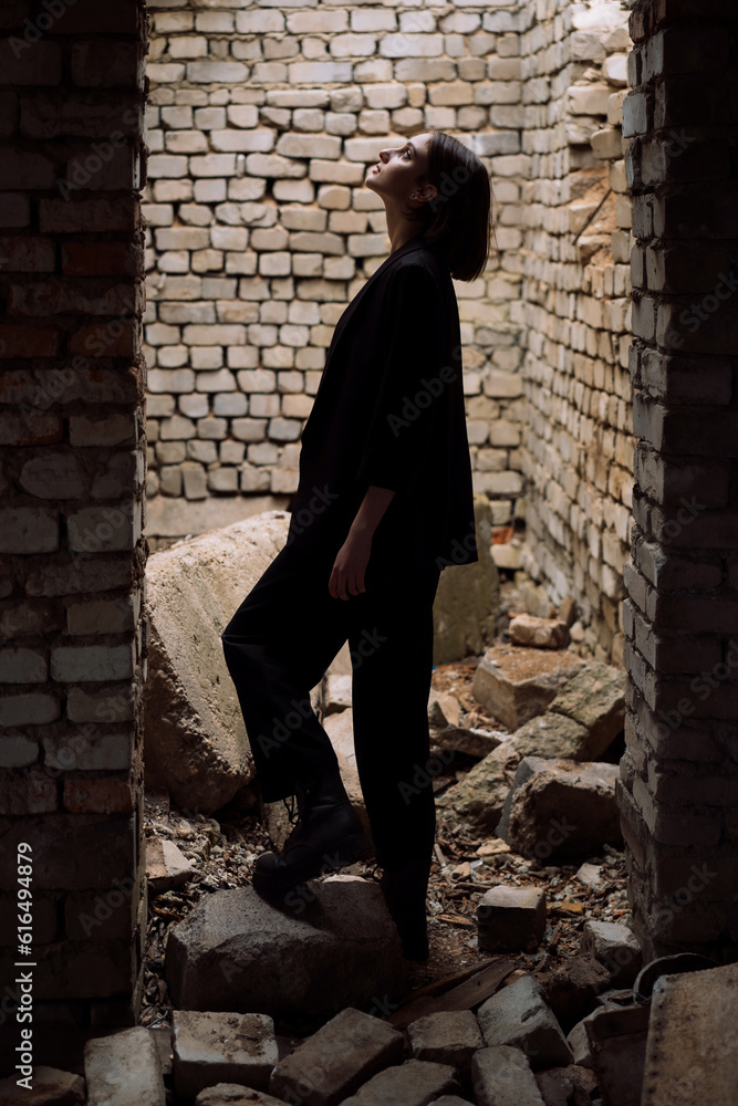 a series of photographs of a girl in a black suit in an abandoned place