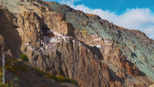 View of the Phugtal monastery built inside the mountain cave during the sunset near Purne in Zanskar Valley, Ladakh, India. Monastery built inside mountains in Zanskar. Remote monastery in India. photo