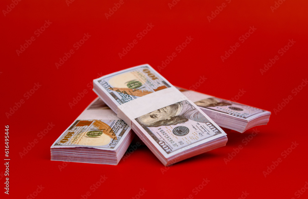 Dollar money on a red background Financial and investment success Salary Investment income Dividend Financial wealth Dollar money on a red background Financial and investment success Salary Investment income Dividend Financial wealth