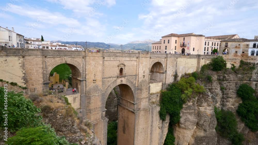 Tourists visit the panoramic landscape views looking over the Punte Nuevo Bridge in the southern region of Malaga in Spain Tourists visit the panoramic landscape views looking over the Punte Nuevo Bridge in the southern region of Malaga in Spain