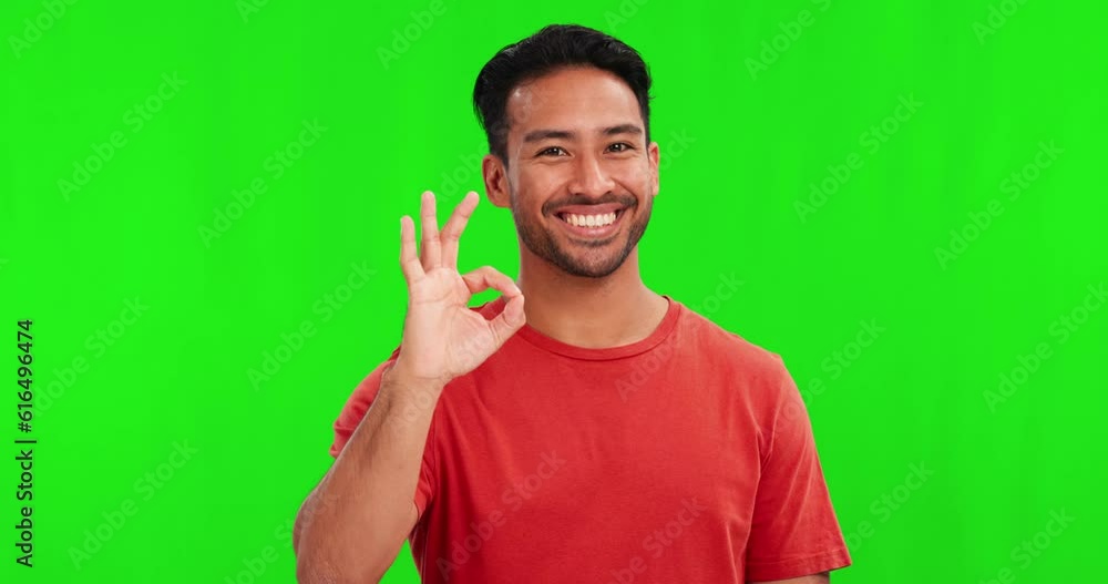 Okay sign, face and man on green screen for success, certified and excellence in casual clothes or tshirt. Happy young, asian person with yes or OK emoji and hand for agreement on studio background Okay sign, face and man on green screen for success, certified and excellence in casual clothes or tshirt. Happy young, asian person with yes or OK emoji and hand for agreement on studio background
