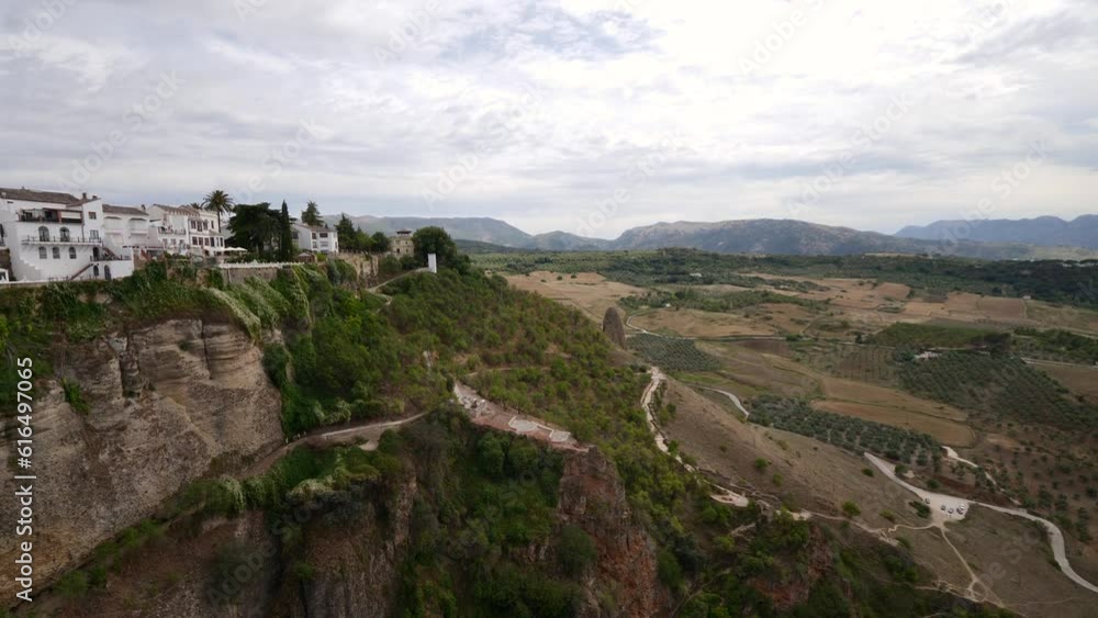 Tourists visit the panoramic landscape views looking over the Punte Nuevo Bridge in the southern region of Malaga in Spain Tourists visit the panoramic landscape views looking over the Punte Nuevo Bridge in the southern region of Malaga in Spain