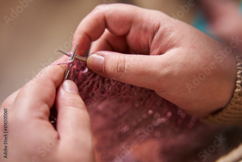 hands of a knitter close-up. A young girl knits knitting needles from pink yarn. hobby  handmade 