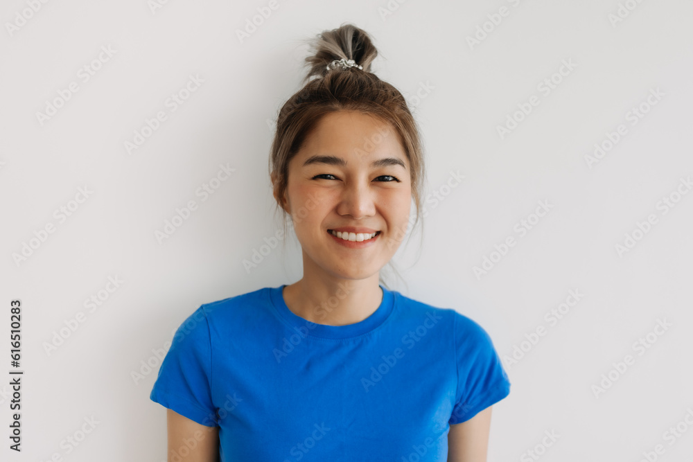 Close up of happy asian woman in blue t-shirt isolated on white. Close up of happy asian woman in blue t-shirt isolated on white.