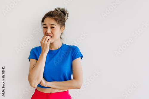 фотографія Asian woman in colorful clothes feeling hesitate isolated on white