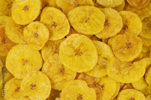 Pile of dehydrated fried banana chips with salt, top view. Chifles, tostones o patacones. Top view of typical traditional dish of Latin American gastronomy called Chifles or fried tostones. Platano. photo