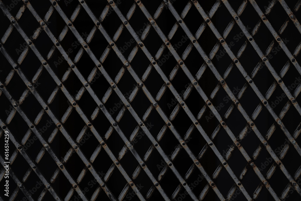 Trellised window. Metal lattices with rhombus pattern. Close-up image. isolated on black background. Window with Wrought Iron Security Bars. Trellised window. Metal lattices with rhombus pattern. Close-up image. isolated on black background. Window with Wrought Iron Security Bars.