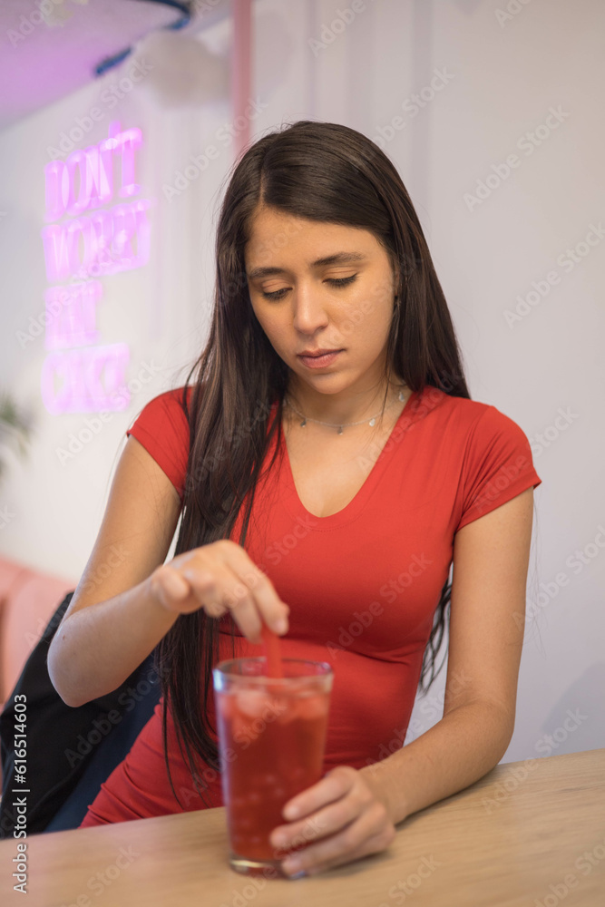 enjoying a refreshing drink, woman with black hair and in a red dress in a restaurant, beauty and glamour, restaurant interior enjoying a refreshing drink, woman with black hair and in a red dress in a restaurant, beauty and glamour, restaurant interior