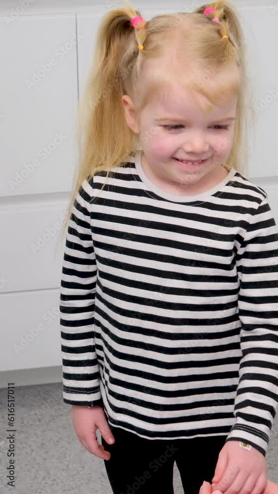 little blond light-skinned girl came for first time to kindergarten to hospital dentistry young woman talking to shaking her head smiling First acquaintance little blond light-skinned girl came for first time to kindergarten to hospital dentistry young woman talking to shaking her head smiling First acquaintance