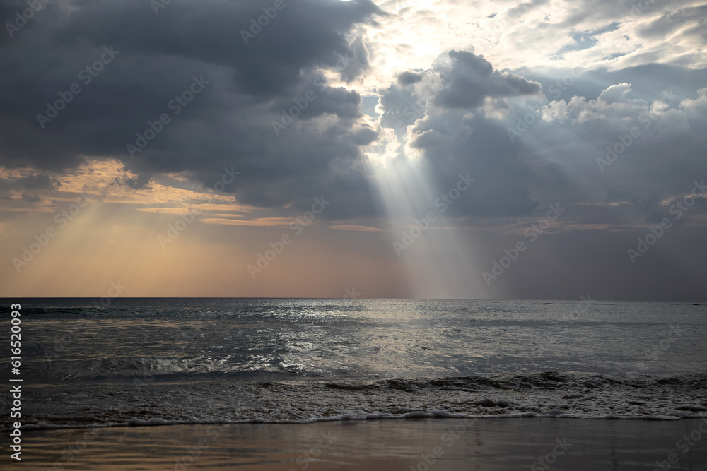 Beautiful rays of light fall into the sea. Cloudy sky. Beautiful light. Sea water. Evening light.