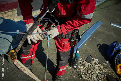 A specialist is repairing the roof. Rope access 