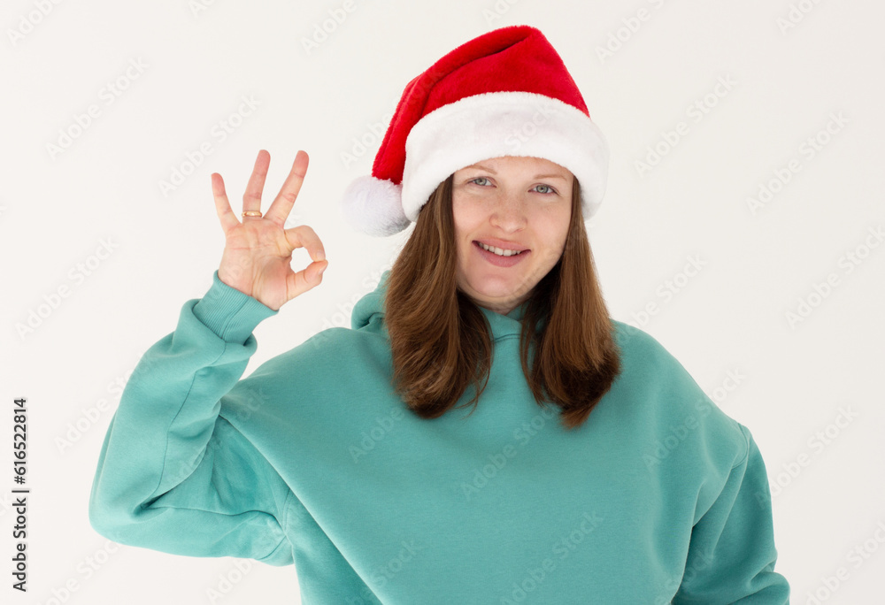 Close up photo of charming pregnant lady showing ok sign recommend event wearing green hoodie isolated over white background Close up photo of charming pregnant lady showing ok sign recommend event wearing green hoodie isolated over white background