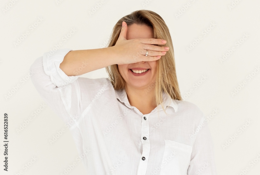 Young pretty woman with hand over eyes, white background Young pretty woman with hand over eyes, white background