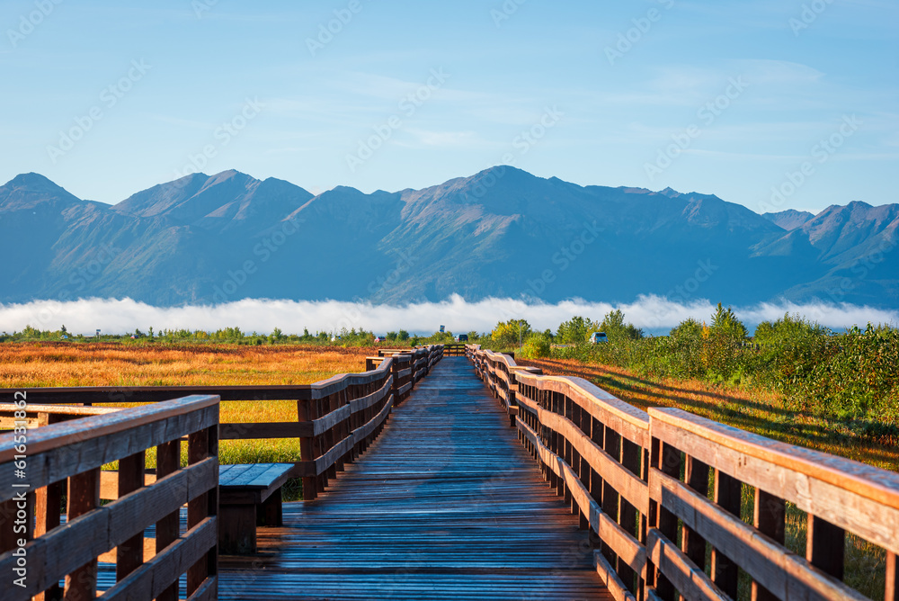 Fototapeta premium A wooden boardwalk in Potter Marsh Bird Sanctuary, Alaska.