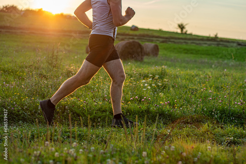 sunset and running young man . man running on meadow at sunset active lifestyle