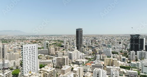 Aerial view of the cityscape of Nicosia, Cyprus. Skyscrapers in the downtown of the city drive traffic from cars. The life of a metropolis on an island. High quality 4k footage