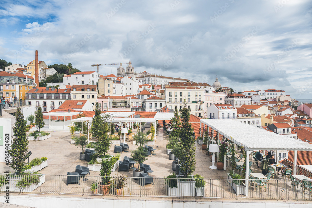 Lisbon, Portugal - March 8, 2023: Al fresco dining on a deck with view of Ocean. Cafe terrace in Lisbon, Portugal