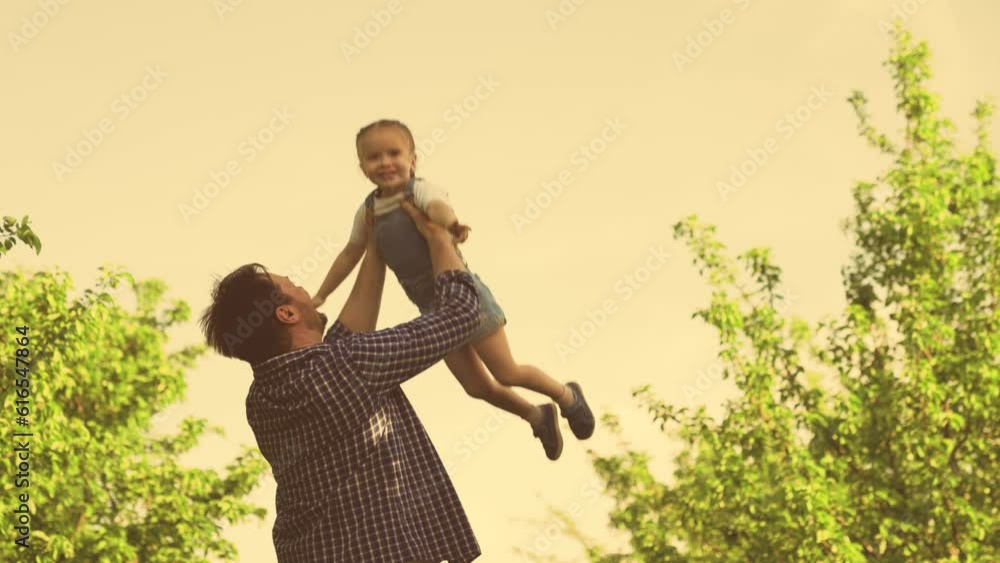 Father plays with his little daughter throws her up in sky. Family game
