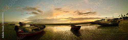 Brazil: wonderful sunset with fishermen's boats on Praia Principal de Jeri, the main beach of Jericoacoara, famous city with the sand streets in the northeast of the South American country