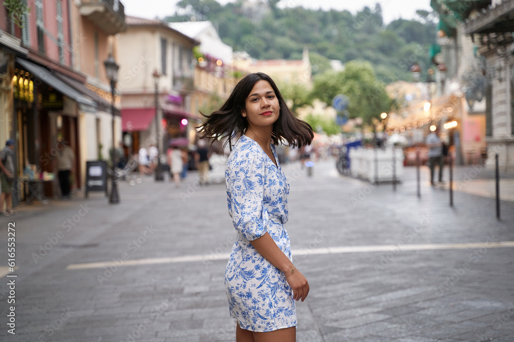 Beautiful young mixed race woman in the old town of Nice, France