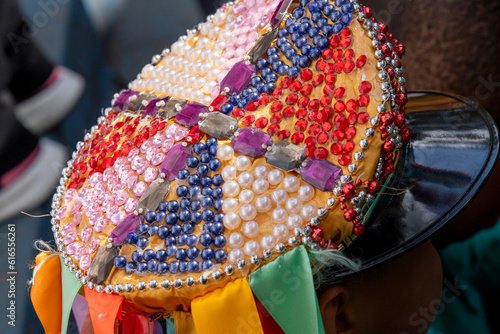 multicolored decoration on the cap and ribbons in the traditional folkloric manifestation of the congada de Santa Ifigênia on the feast of Our Lady of Rosary of Black Men. São Paulo Brazil photo