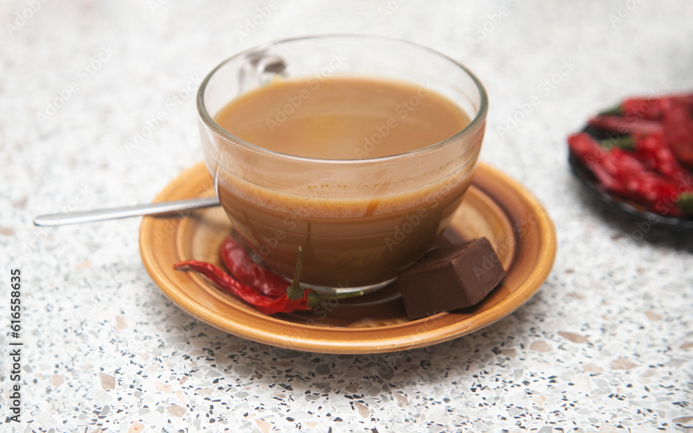cup of coffee with chocolate and chili red pepper on the table cup of coffee with chocolate and chili red pepper on the table