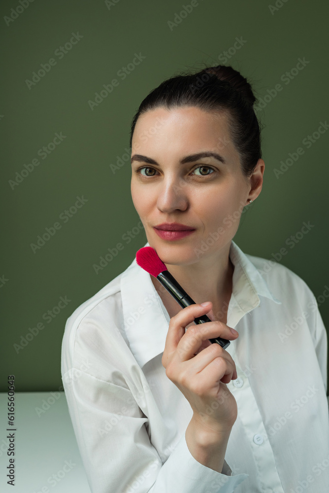 Makeup artist powder and brush . Make up in process. European woman uses makeup brush Makeup artist powder and brush . Make up in process. European woman uses makeup brush