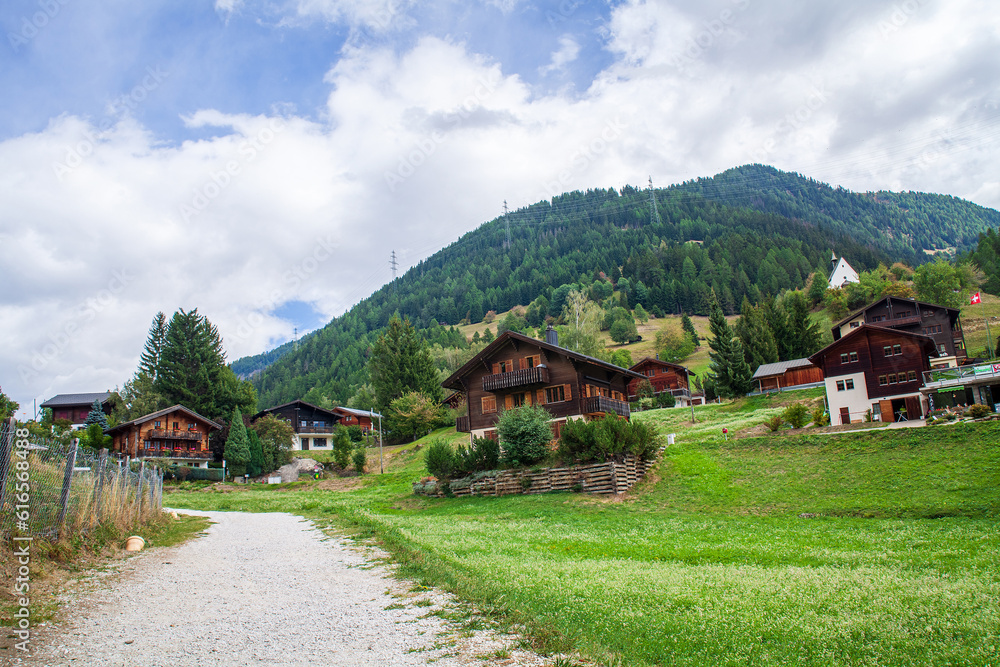 Mountain village in Alps, Switzerland. Summer landscape with mountain village.