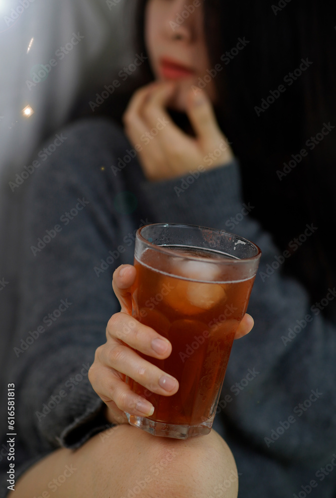 Woman holding glass, drunk because of beer, alcoholic drink taste concept.
Woman holding glass, drunk because of beer, alcoholic drink taste concept.