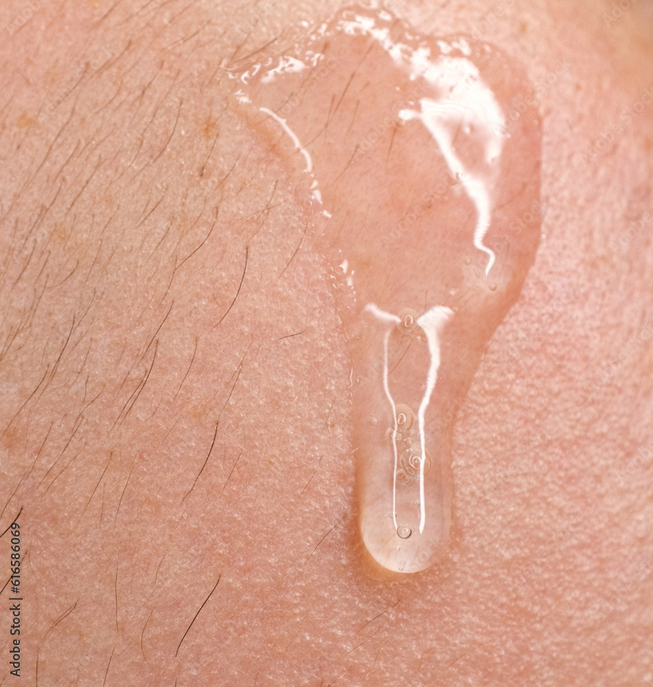 Fototapeta premium clear serum dripping down skin 