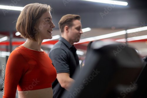 Group people workout with walking and exercise on machine treadmill together in fitness gym sport club, man and woman cardio with training jogging, diversity and ethnicity, healthcare and motivation.