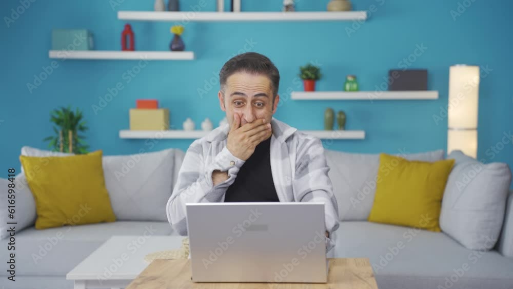 Man looking at laptop in amazement. Man looking at laptop in amazement.