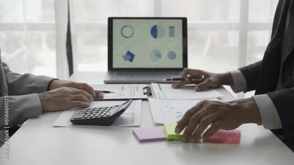 Asian male businessman with two financial advisers analyzing chart data in document Use files and documents to create on your laptop with colleagues working in Office 4K. Asian male businessman with two financial advisers analyzing chart data in document Use files and documents to create on your laptop with colleagues working in Office 4K.