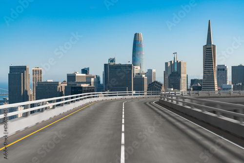 Empty urban asphalt road exterior with city buildings background. New modern highway concrete construction. Concept way to success. Transportation logistic industry fast delivery. San Francisco. USA.