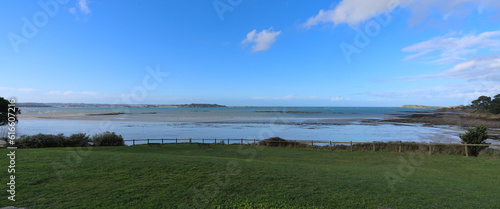 View from park with brunch table of a sand beach during low tide a winter sunny afternoon  Lancieux  Brittany  north of France