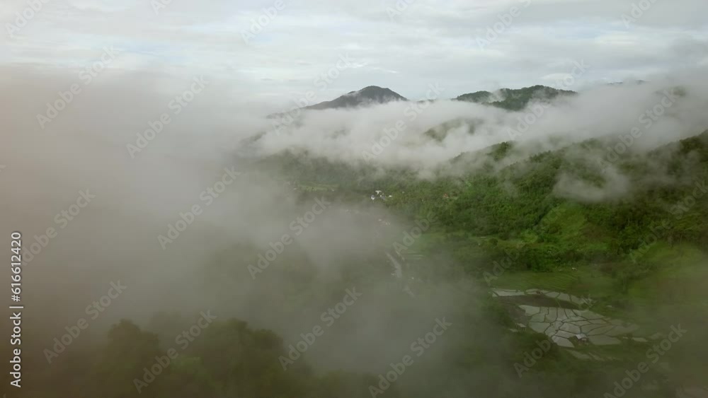 Aerial view flying above lush green tropical rain forest mountain with rain cloud cover during the rainy season on the Doi Phuka Mountain reserved national park the northern Thailand