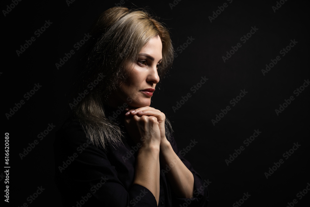 Cute beautiful girl folded her hands in prayer. A woman asks God for help Cute beautiful girl folded her hands in prayer. A woman asks God for help