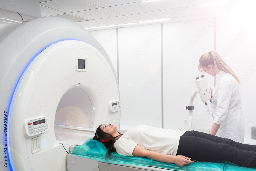 Medical CT or MRI Scan in the modern hospital laboratory. Interior of radiography department. Technologically advanced equipment in white room. Magnetic resonance diagnostics machine Medical CT or MRI Scan in the modern hospital laboratory. Interior of radiography department. Technologically advanced equipment in white room. Magnetic resonance diagnostics machine