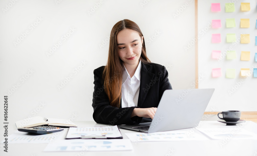 businesswomen sit at their desks and calculate financial graphs showing results about their investments, planning successful business growth processes in the office businesswomen sit at their desks and calculate financial graphs showing results about their investments, planning successful business growth processes in the office