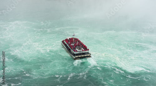 Niagara Falls boat tours attraction. Tourist people sailing on the travel boat close to the Niagara Horseshoe Fall