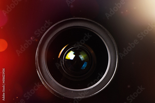 camera photo lens with glare effect on black background.