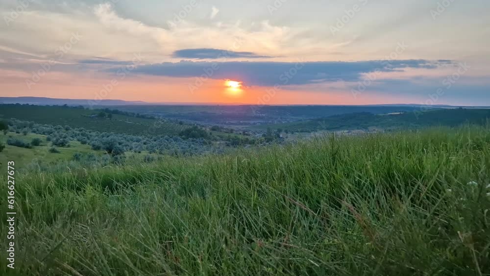 Summer sunset landscape with a view over the green valley Summer sunset landscape with a view over the green valley