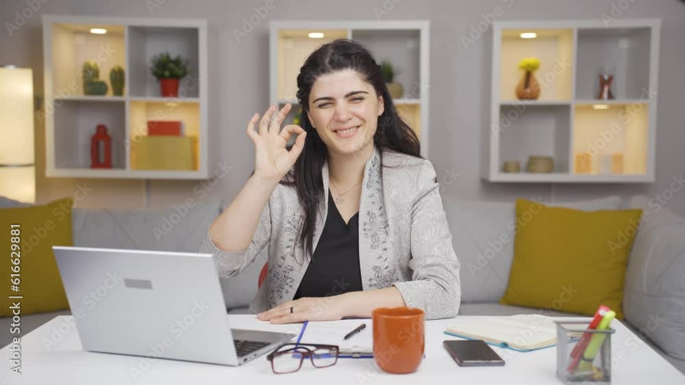 Home office worker woman making positive gesture at camera. Home office worker woman making positive gesture at camera.