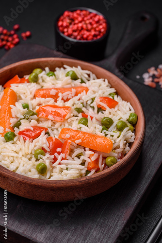 Delicious boiled rice with vegetables or risotto with salt, spices and herbs