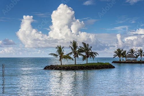 Bright heavenly tropical beach Upolu Island, Samoa in the Pacific Ocean, a small island with palm trees. Summer, picturesque cumulus clouds in the blue sky, heaven, sun, great vacation and travel.
