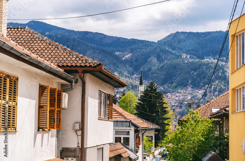 Street in Sarajevo with old private houses overlooking the city. Beautiful urban summer landscape. Travel to the Bosnia and Balkans