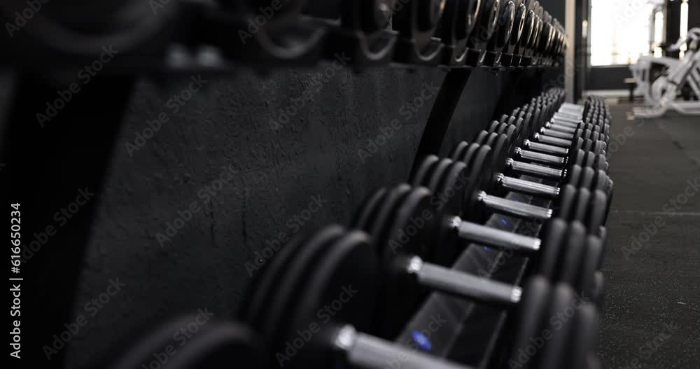 Set of rack with dumbbells of same size for training closeup. Independently choose working weight of dumbbells and weights Set of rack with dumbbells of same size for training closeup. Independently choose working weight of dumbbells and weights